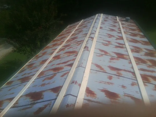 Rusted metal roof panels with new wood purlins before replacement — Storm Damage Roof Repair in Ashford by Roofing Brothers